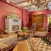 Pêche De Vigne & Spa in Rodern lobby with ornate chess table, red sofa, carved cabinet and chandelier