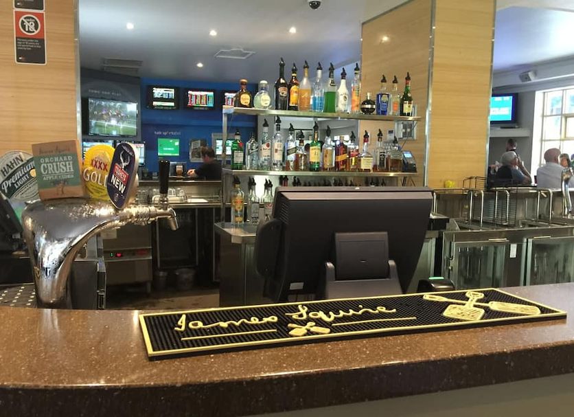 Port Macquarie Hotel bar with beer taps, liquor shelves and TV screens in Port Macquarie