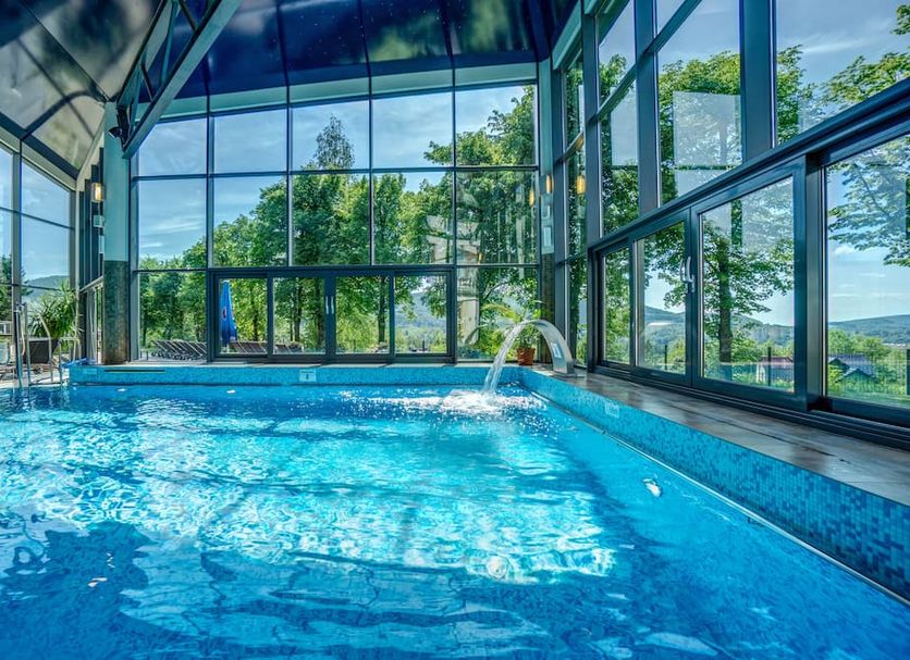 Indoor pool with floor-to-ceiling windows and mountain views at Hotel Diament Ustron, Ustroń