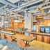 ONE@Tokyo by insomnia in Tokyo lobby with communal tables, bar seating and industrial ceiling