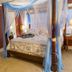 Fairfield Manor Bed and Breakfast in Shreveport, four-poster bed with blue canopy in a cozy guest room