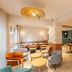 Logis Hôtel de Port d'Alon - St Cyr sur Mer breakfast room with tables, chairs, and warm pendant lights