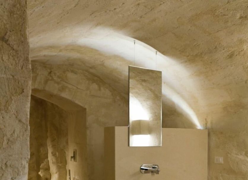 Corte San Pietro in Matera, stone-vaulted bathroom with vessel sink, mirror, and walk-in shower