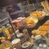 Campanile Conflans-Sainte-Honorine breakfast buffet with pastries, bread, jams and utensils