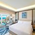 Hilton Hurghada Plaza room with king bed, ocean-view balcony, and seating area in Hurghada