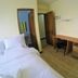 Relax Divers-Pg in Puerto Galera guest room with two beds, desk, chair, and mini fridge