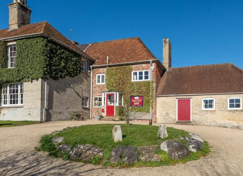 Manor Farm B&B in Marlborough, stone country house with red doors and ivy-covered facade