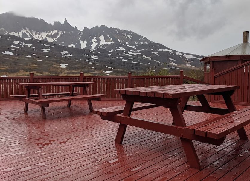 Engimyri Lodge in Akureyri with wet deck picnic tables and mountain views