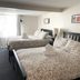 Douglas Guest House Vancouver guest room with two beds, a window and framed wall art