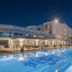 Dona Filipa Hotel in Almancil with lit outdoor pool and terrace at dusk