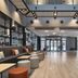 Dorma Juan De Austria in Valladolid lobby with modern seating, glass walls, and a high ceiling