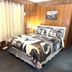 Evening Shade River Lodge & Cabins Chimney Rock room with log cabin walls and a queen bed