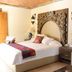 Hotel Lindo Ajijic Bed & Breakfast room in Ajijic with carved wood headboard and colorful bed runner