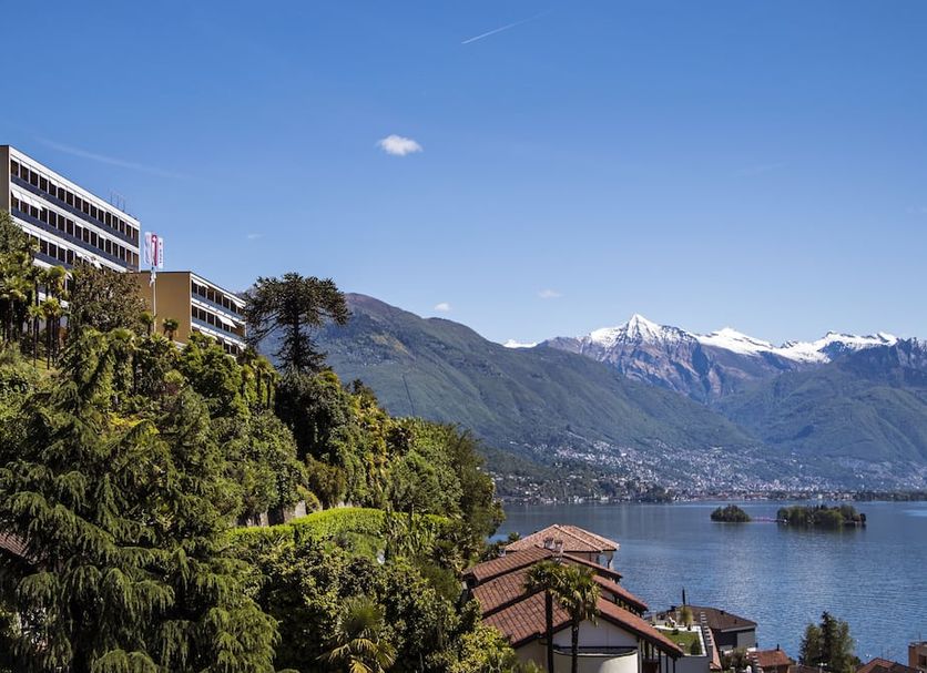 Parkhotel Brenscino Brissago overlooking Lake Maggiore, mountains, and a hillside garden