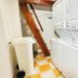 Hostal Casa Torres Centro Historico in Cartagena laundry area with stacked washer and dryer and trash bin