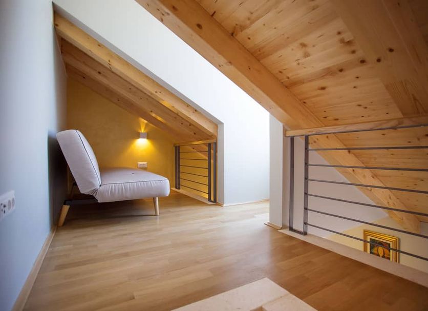 Mijama Suites Split loft room with wooden ceiling, lounge chair and stair railing