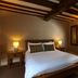 Broom Hall Inn in Alcester bedroom with double bed, exposed beams, and bedside lamps