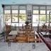 Erato Hotel in Agia Marina dining room with wooden tables, chairs, and red sofas near large windows