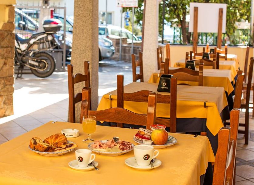 Hotel San Francisco in Dorgali restaurant tables set for breakfast near the open streetfront