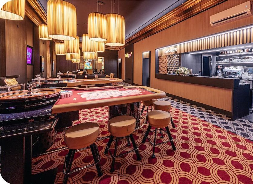 Grandhotel Brno in Brno: stylish casino-style lounge with gaming tables and hanging pendant lights