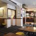 Tongadale Hotel in Portree: cozy lounge bar with wooden tables, stools, and a carpeted seating area