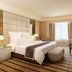 One World Hotel in Petaling Jaya guest room with king bed, desk, window curtains and upholstered bench