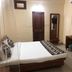Goroomgo Mourya Inn Madhya Pradesh room in Harda with bed, wardrobe, TV and mirror