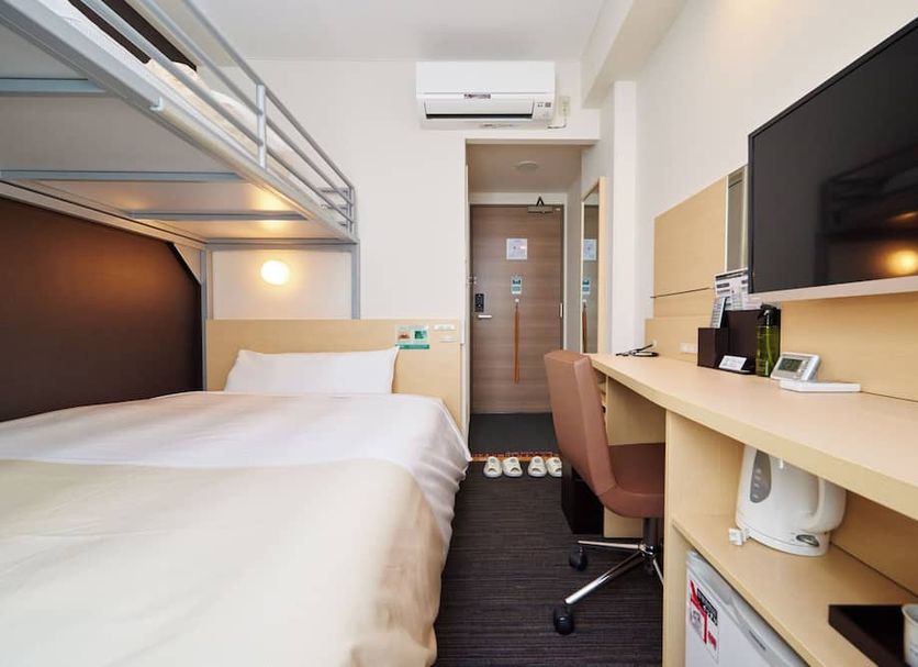 Super Hotel JR Nara Ekimae Sanjodori room with bunk bed, desk, chair, and wall-mounted TV in Nara