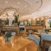 Iberostar Waves Berkeley Shore in Miami Beach dining room with round tables, booths and warm pendant lighting
