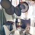 Il Camaleonte dal 2005 in Bracciano: compact kitchen with hanging pots, stove, coffee maker and counter