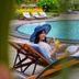 Guest relaxing on poolside lounger at The Jayakarta Yogyakarta Hotel & Spa in Yogyakarta