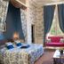 Château de Noizay room in Noizay with canopy bed, tall drapes, pink loveseat and fireplace