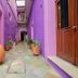 Hotel Posada Don Matias in Oaxaca: purple courtyard corridor with potted plants and wooden doors