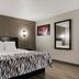 Red Roof Inn Hartford - New Britain guest room with king bed, wall sconces and mirror