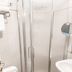 Hotel Le Cinéma, Gatteo bathroom with frosted glass shower, toilet, sink and towels