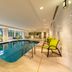 Hilton Garden Inn Winchester indoor pool with lounge chairs and large windows