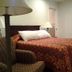 Arrowhead Mountain Inn Lake Arrowhead guest room with bed, chair, lamp and window