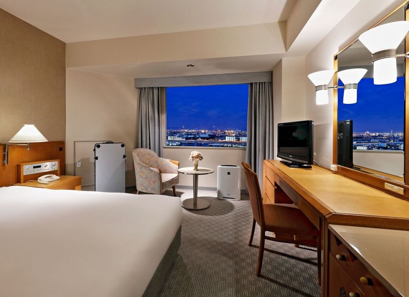 Miyako Hotel Amagasaki guest room with city view, desk, chair and window seating in Amagasaki