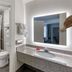 SureStay Plus by Best Western Asheboro bathroom with granite vanity, lit mirror and tub-shower combo