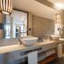 Pousada dos Sonhos bathroom in Florianopolis with double sinks and a glass-enclosed shower