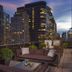 Wyndham Midtown 45 in New York rooftop terrace with city skyline and lounge seating at dusk