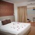 Baan Klang Hua Hin guest room with king bed, flower petals, and balcony seating in Hua Hin