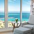 Hilton Hurghada Plaza in Hurghada with a sea view from a window beside a gray armchair