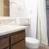 Bryce Uptop Lodge bathroom with sink, toilet, mirror and shower curtain in Bryce