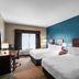 The Hotel Saratoga in Saratoga Springs guest room with two double beds and teal accent wall