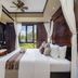 Nirwana Resort Hotel Tanjung Pinang bedroom with canopy bed and balcony garden view