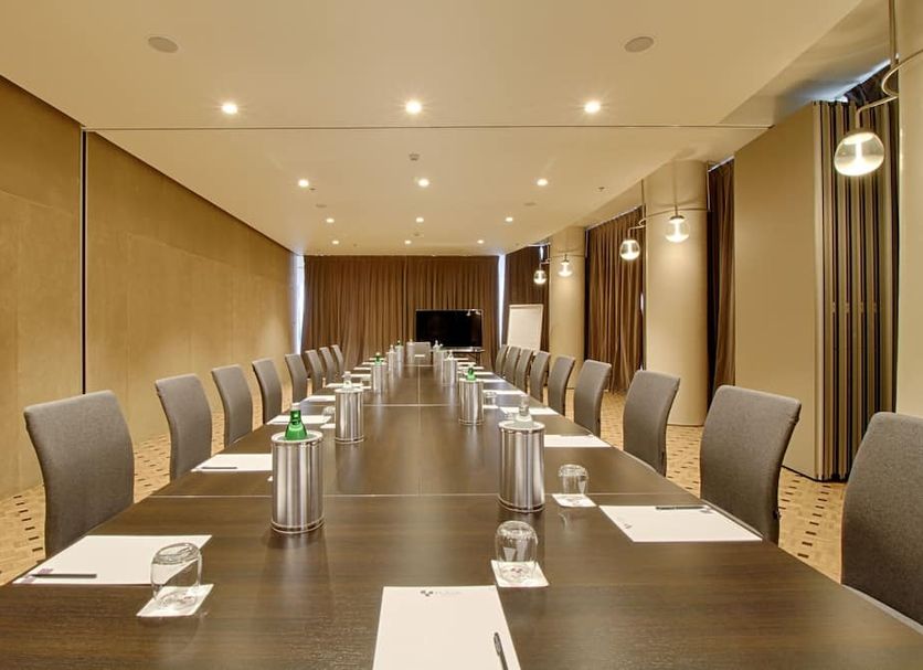 Maritim Hotel Plaza Tirana meeting room with long conference table and rows of chairs in Tirana