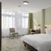 flexymotel Buchs guest room with double bed, desk, chair, and large window in Buchs