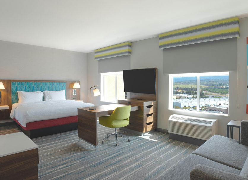 Hampton Inn Santa Clarita-Valencia guest room with king bed, desk, sofa and city view