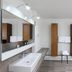 Alpina Löwen Hotel bathroom in Sankt Märgen with double sink, wood cabinets and open door